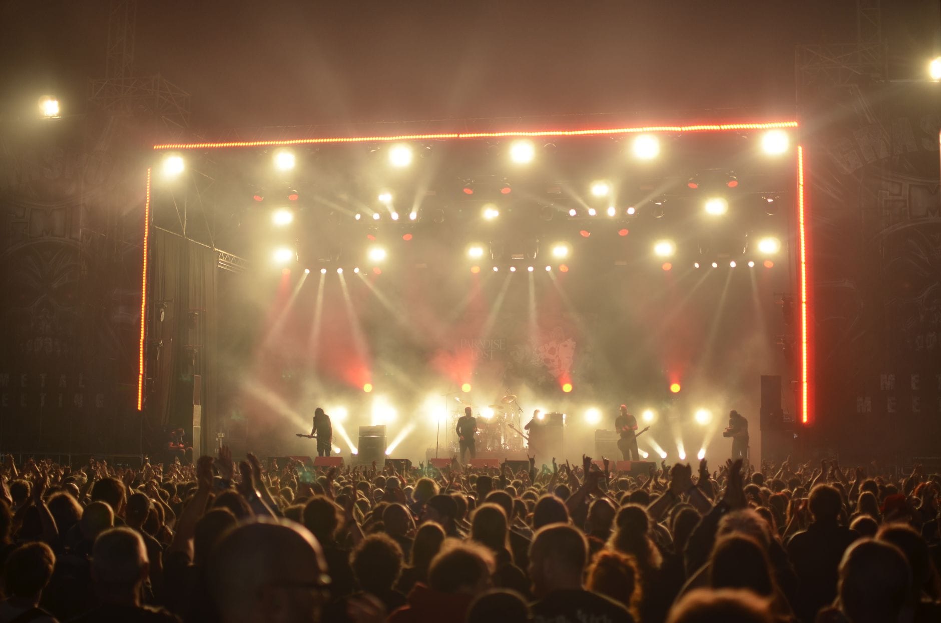 Największe katastrofy sceniczne w rocku i jak ekipy ratowały koncerty w ostatniej chwili Zespół rockowy na scenie, efekty świateł i entuzjastyczny tłum nocą